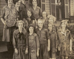 Julia Veitch Thomas started Arlington's first Girl Scout troop. She is seen here with the Girl Scouts and believed to be on her front porch about 1920.